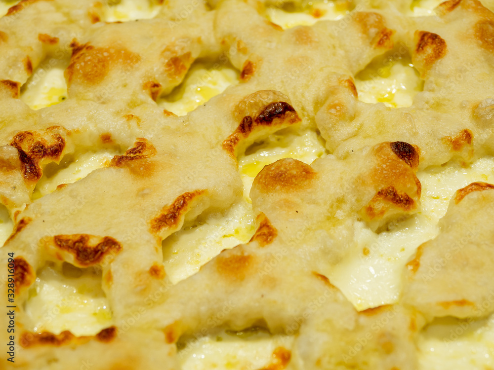 Delicious Italian pizza cooked in the wood oven with different kind of melted cheese Delicious Italian pizza cooked in the wood oven with different kind of melted cheese