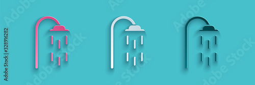 Paper cut Shower head with water drops flowing icon isolated on blue background. Paper art style. Vector Illustration