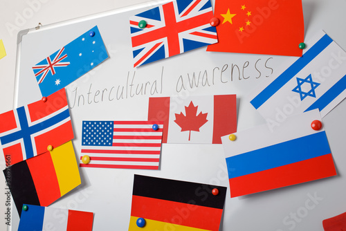 School whiteboard with flags of different countries with inscription Intercultural awareness