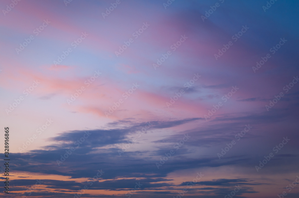 Colorful sunset sky over the horizon. Layered clouds.