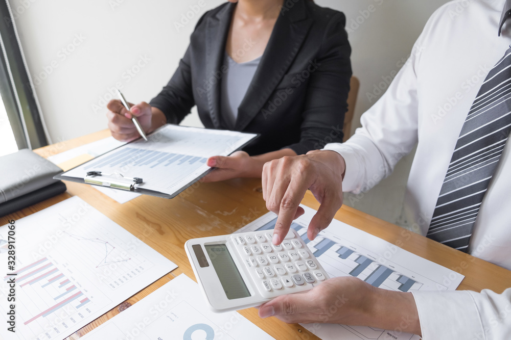Businessman using calculator on the table in the office room Businessman using calculator on the table in the office room