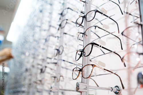 Image of a glasses showcase in a modern optic shop, selective focus. © Vadim