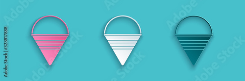 Paper cut Fire cone bucket icon isolated on blue background. Metal cone bucket empty or with water for fire fighting. Paper art style. Vector Illustration