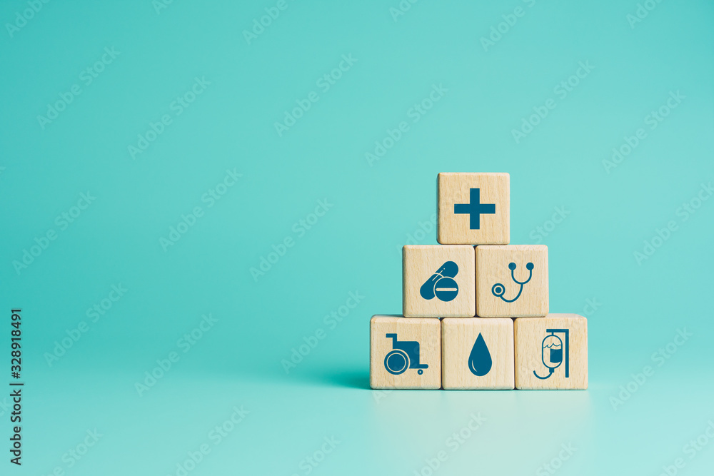 Health insurance concept, Wood blocks with healthcare medical icons on blue background, copy space - obrazy, fototapety, plakaty 