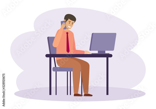 Male manager is working on a computer and talking on the phone