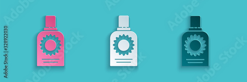 Paper cut Sunscreen spray bottle icon isolated on blue background. Protection for the skin from solar ultraviolet light. Paper art style. Vector Illustration