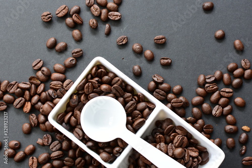 Colombian coffee beans, displayed in containers and spoons