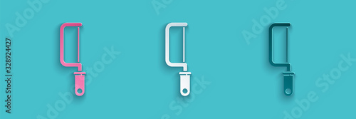 Paper cut Hacksaw icon isolated on blue background. Metal saw for wood and metal. Paper art style. Vector Illustration