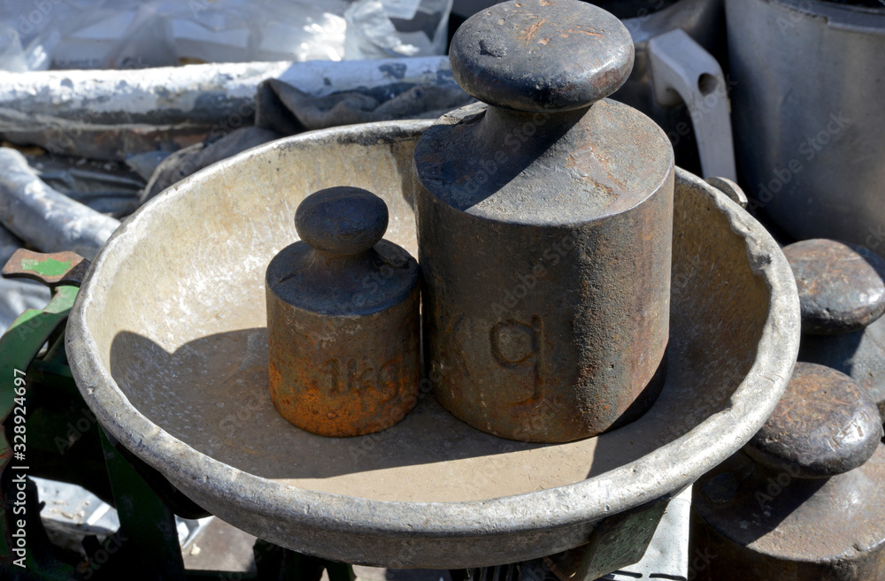 old weights and scales on a background old weights and scales on a background