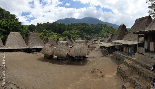 An inside view on the traditional Bena village in Bajawa, Flores, Indonesia. There are many small houses around. Each house is made of natural parts like wood and straw. History and tradition photo