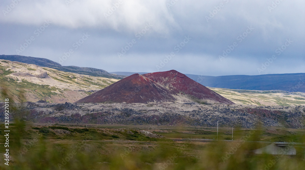 Krafla, Iceland volcanic landscape high angle view of road highway near lake Myvatn with colorful vibrant red mineral hill.