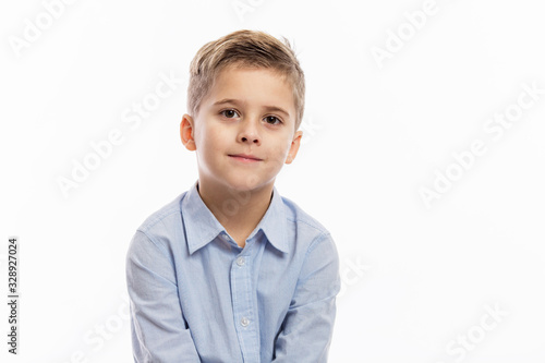 Laughing school boy in a blue shirt. Isolated over white background.