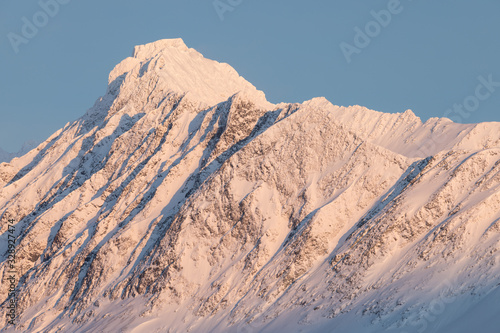 Panorama of snowy fjords and mountain range, Senja, Norway Amazing Norway nature seascape popular tourist attraction. Best famous travel locations. beautiful sunset within the amazing winter landscape