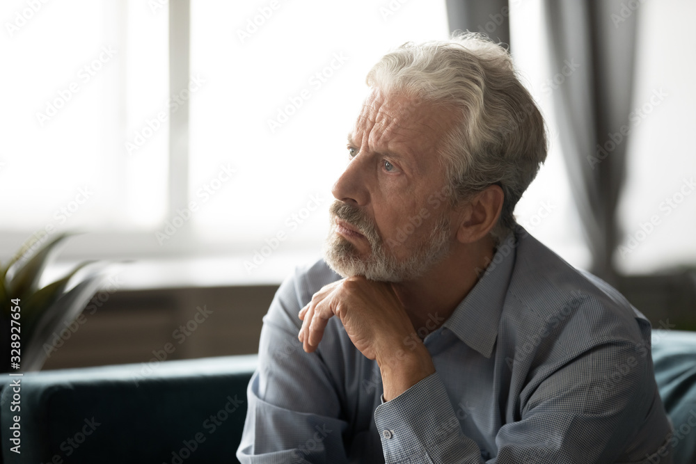 Pensive depressed elderly male look in distance thinking pondering at home, thoughtful unhappy mature man lost in thoughts feel lonely abandoned, mourn or yearn, old people solitude concept Pensive depressed elderly male look in distance thinking pondering at home, thoughtful unhappy mature man lost in thoughts feel lonely abandoned, mourn or yearn, old people solitude concept