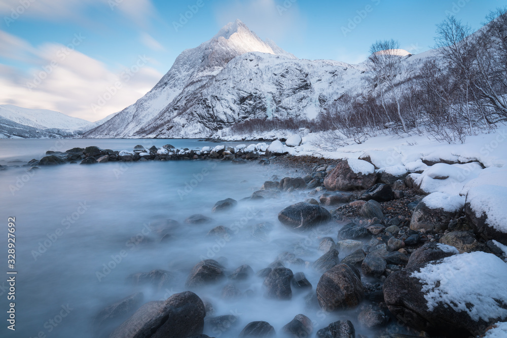 Panorama of snowy fjords and mountain range, Senja, Norway Amazing Norway nature seascape popular tourist attraction. Best famous travel locations. beautiful sunset within the amazing winter landscape