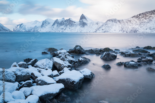 Panorama of snowy fjords and mountain range, Senja, Norway Amazing Norway nature seascape popular tourist attraction. Best famous travel locations. beautiful sunset within the amazing winter landscape