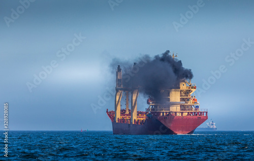 Cargo ship emitting large amount of black smoke