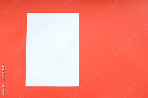 blank white sheet of paper on a red background © metelevan