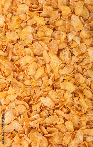 Cornflakes background, texture. Crispy cereal breakfast top view