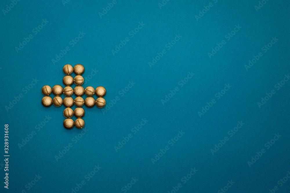 pills in cross shape on blue background