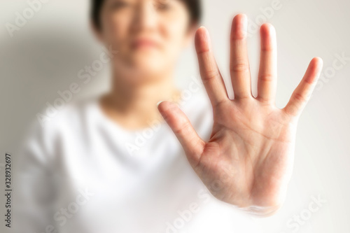 Wallpaper Mural A woman showing a palm with five fingers meaning stop and warning to do not do something; selective focus at the palm and blurred other parts. Torontodigital.ca