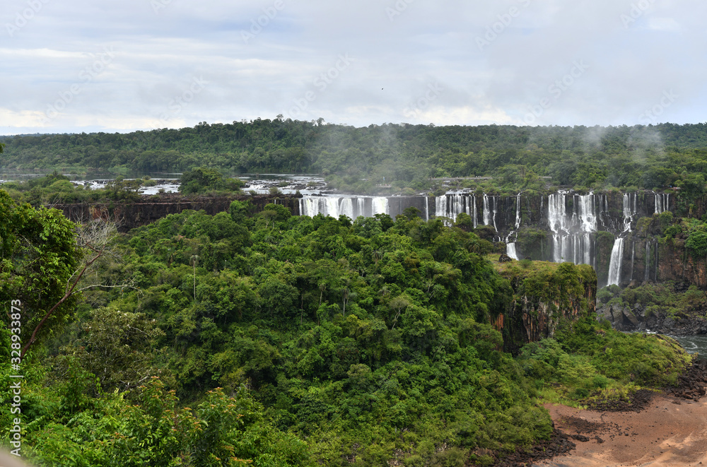 Iguazu roaring waterfalls against a jungle and gray sky Iguazu roaring waterfalls against a jungle and gray sky
