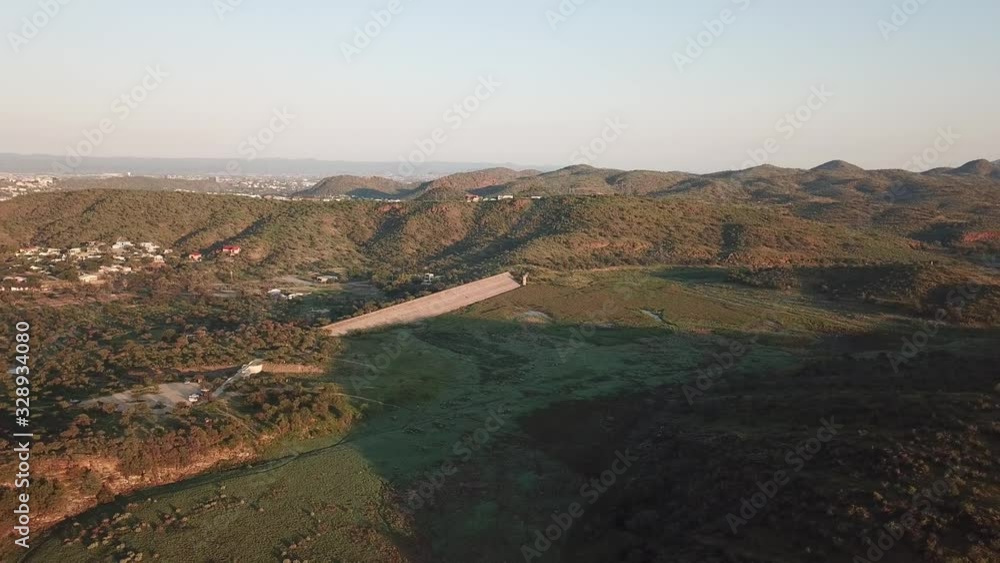 4K aerial drone video of greeen savanna hills and Avis Dam near historical railway bridge on main B6 road from Windhoek to Gobabis in central highland Khomas Hochland of Namibia, southern Africa 4K aerial drone video of greeen savanna hills and Avis Dam near historical railway bridge on main B6 road from Windhoek to Gobabis in central highland Khomas Hochland of Namibia, southern Africa