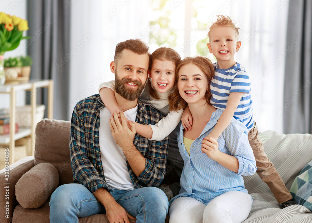 happy family mother father and kids at home on couch . happy family mother father and kids at home on couch .