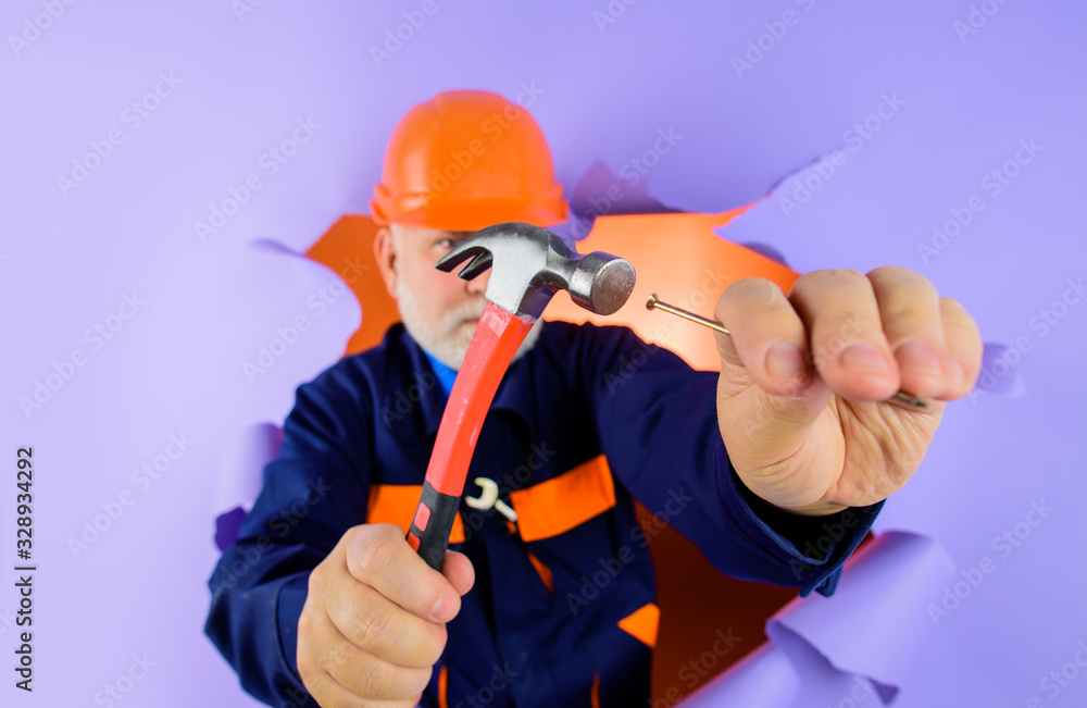 Carpenter hammering nail. Architecture and home renovation concept. Construction worker in helmet. Repairment tools. Hammer and nails. Builder. Worker hammers nails. Repairman. Engineer. Hard hat. Carpenter hammering nail. Architecture and home renovation concept. Construction worker in helmet. Repairment tools. Hammer and nails. Builder. Worker hammers nails. Repairman. Engineer. Hard hat.