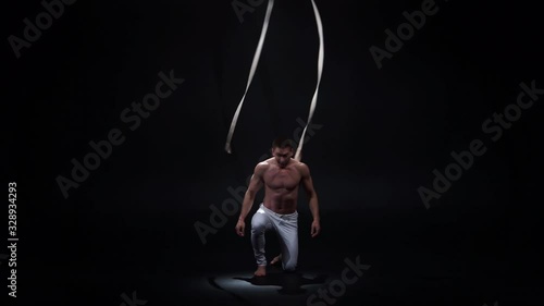 Muscular circus artist on the aerial straps. Concept of power, health and wellness  photo