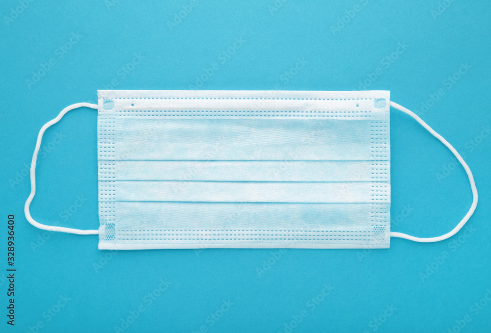 Medical mask on a blue background with copy space. Coronavirus Medical mask on a blue background with copy space. Coronavirus