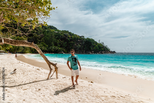 Seychelles tropical Island, Young man on the white beach during Holiday vacation Mahe Seychelles, Praslin Seychelles photo