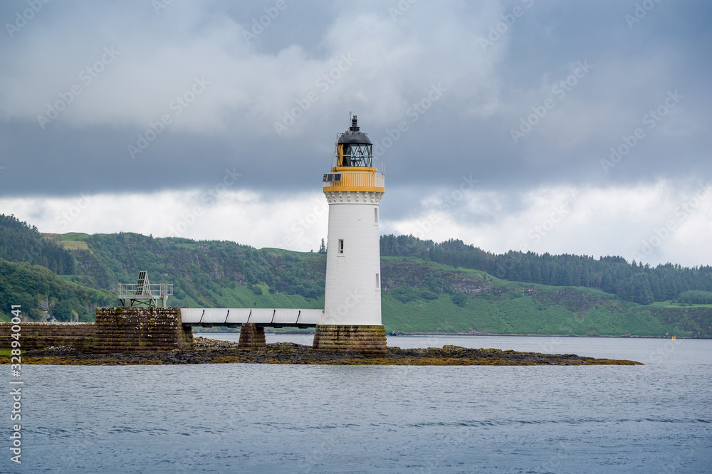 Tobermory Lighthouse view from the water. Island of Mull north cape, Scotland.