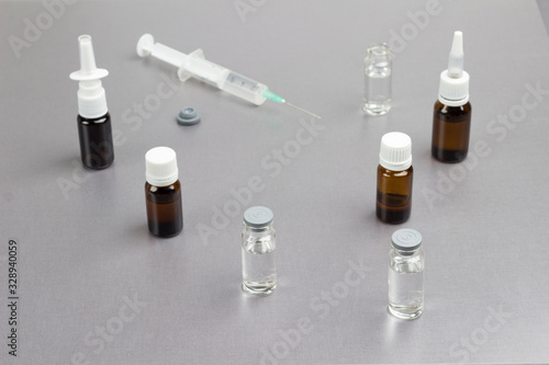 Glass Bottle with medicines and syringe. Cold remedies. Medical concepts and medicines