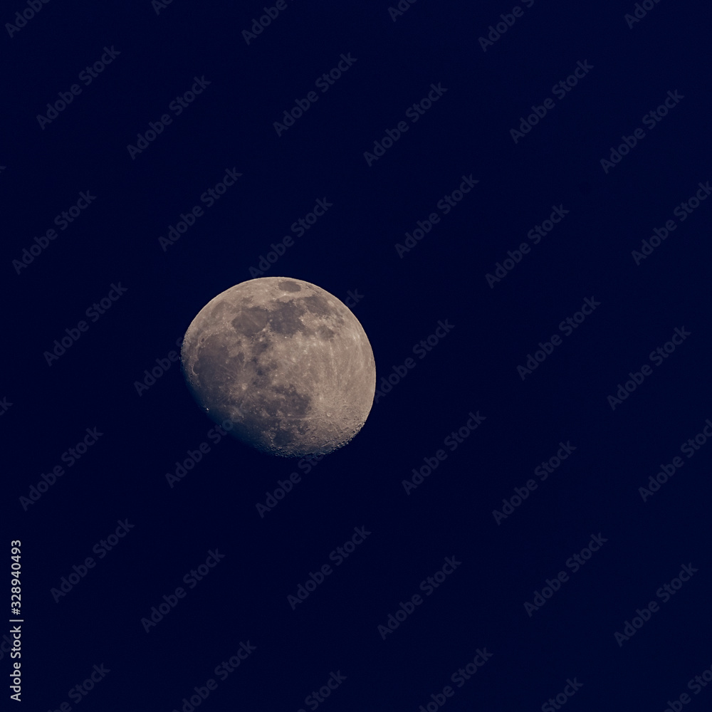 nearly full moon on dark blue background nearly full moon on dark blue background