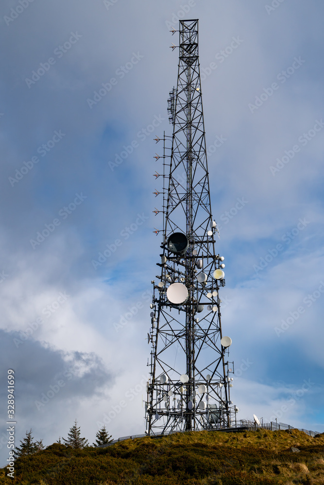 (BTS) Base transceiver station  with antenna isolated on blue sky background. Telecommunications radio tower cells