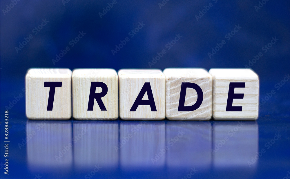 concept word trade on cubes on a blue background concept word trade on cubes on a blue background