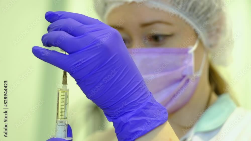 nurse draws medicine into syringe nurse draws medicine into syringe