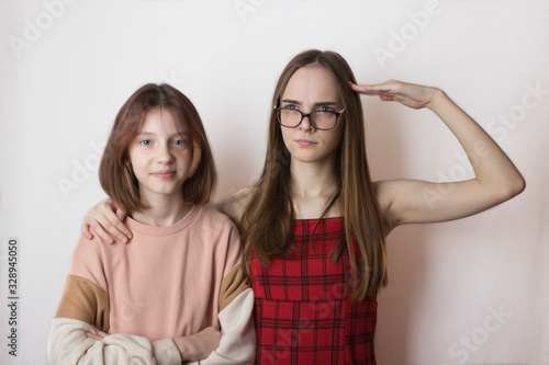 Fotografie stepsisters or friends children teens not like each other on a white background