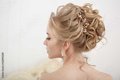 Bride with wedding flowers bouquet. Woman in wedding dress. Young fashion model with perfect skin, make up and Beautiful Hairstyle. Happy day. Marriage.