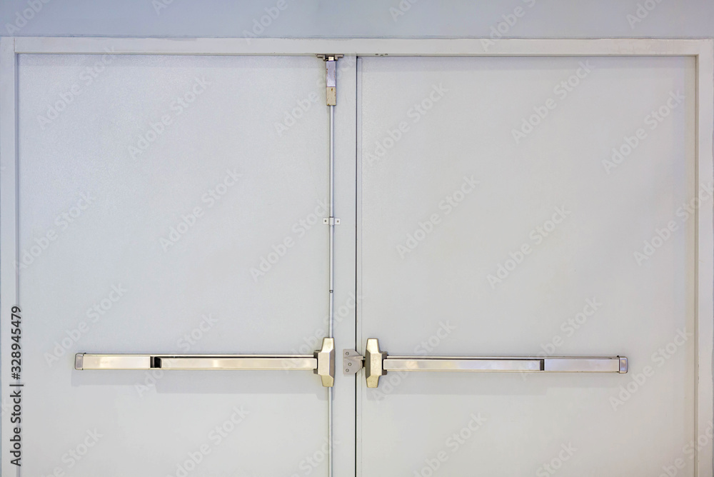 Emergency fire exit door. Closed up latch and rusty door handle of