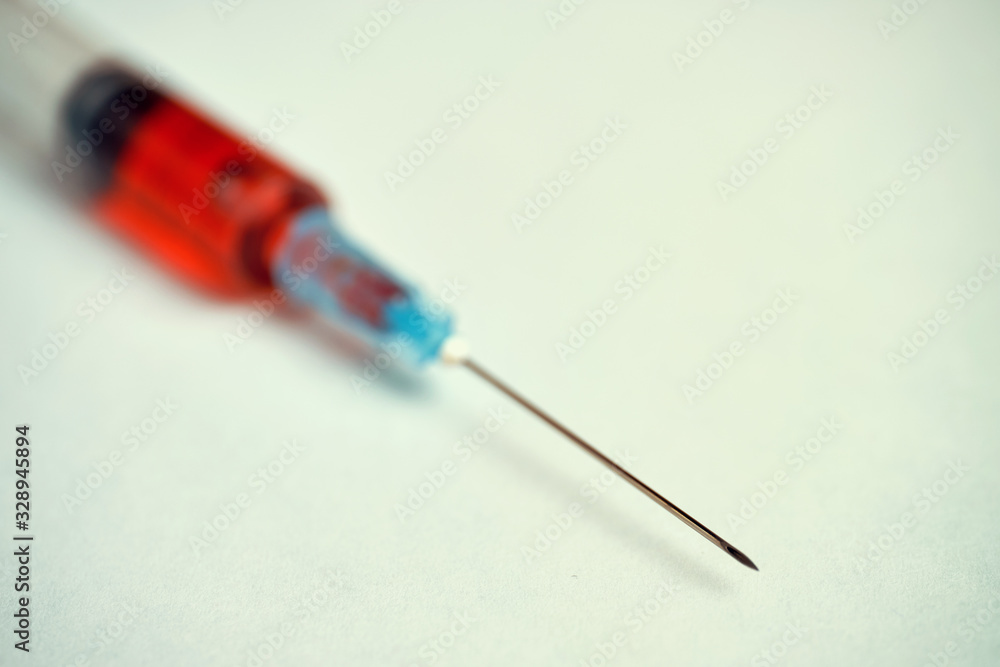 Syringe with red substance. Toned Syringe with red substance. Toned