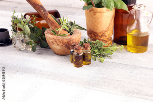 Fototapeta Naklejka Na Ścianę i Meble -  Homegrown and aromatic herbs on rustic background with rosemary and basil