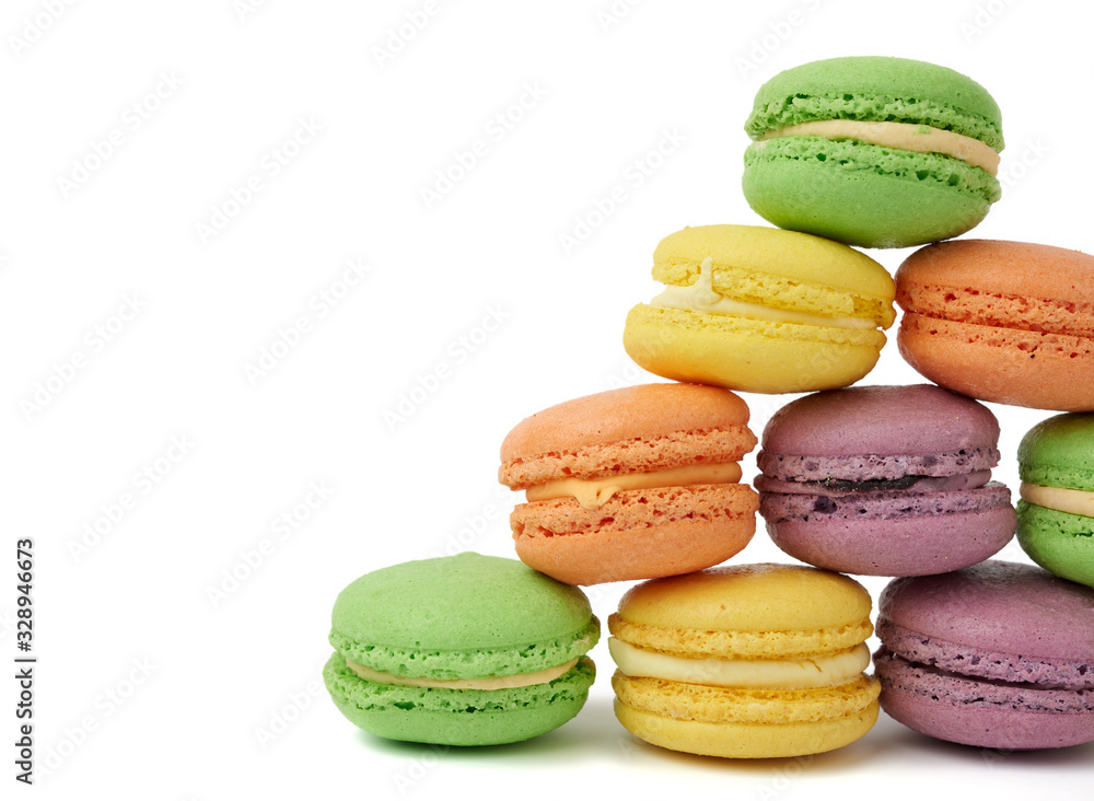 round baked multi-colored almond flour cakes macarons, dessert is laid in a stack round baked multi-colored almond flour cakes macarons, dessert is laid in a stack
