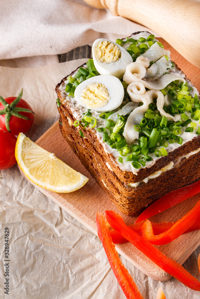 a huge herring sandwich with mayonnaise and quail eggs a huge herring sandwich with mayonnaise and quail eggs