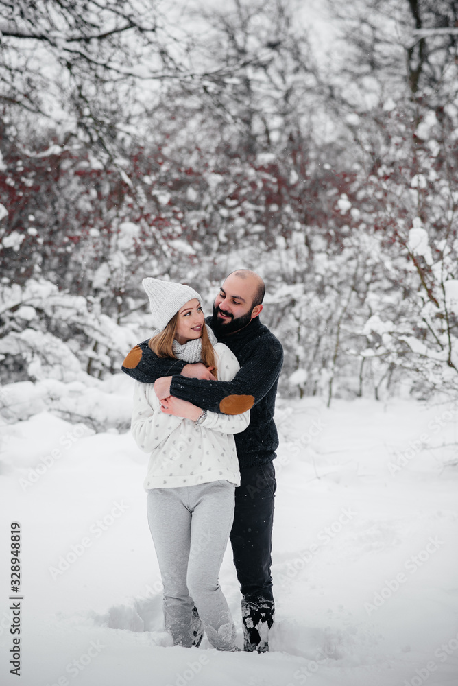 Couple playing with snow in the forest Couple playing with snow in the forest