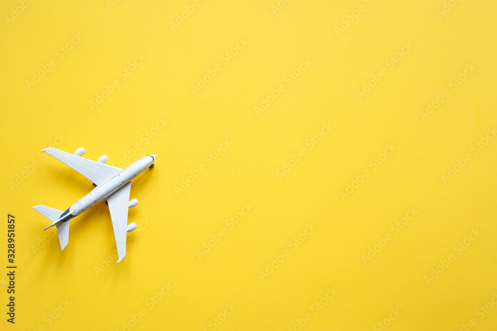 Toy plane on a pastel yellow background with top view and copy space. Travel concept. Toy plane on a pastel yellow background with top view and copy space. Travel concept.