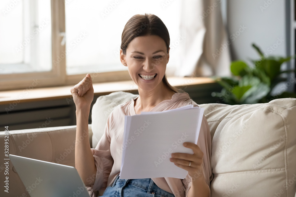 Excited young woman reading paper documents, making yes gesture. Happy lady amazed by good news notification. Surprised student getting university approval, worker receive salary increase notice. Excited young woman reading paper documents, making yes gesture. Happy lady amazed by good news notification. Surprised student getting university approval, worker receive salary increase notice.