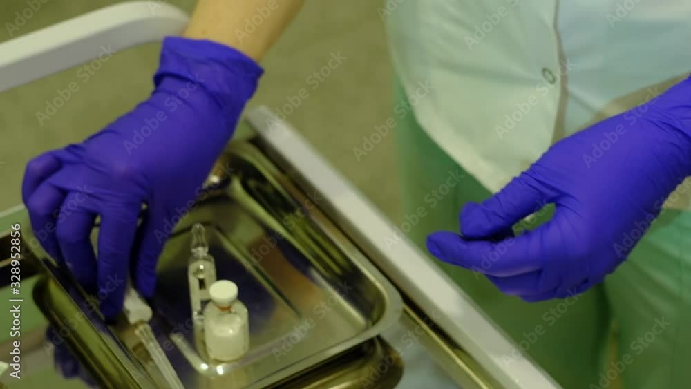 nurse picks up medicine with a syringe nurse picks up medicine with a syringe