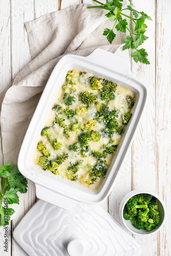 Foto Broccoli and cheese casserole on white wooden background